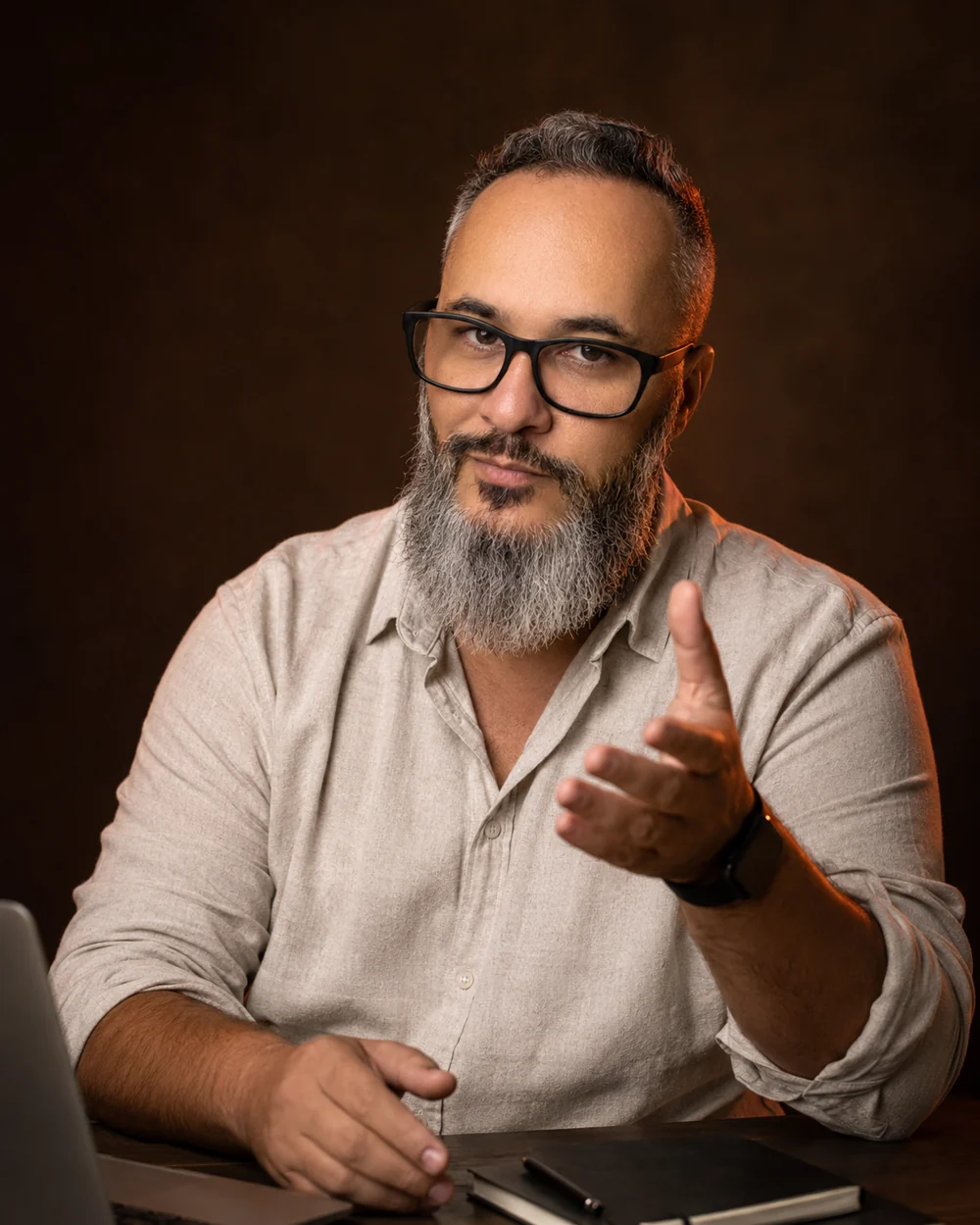 Fabio Rodrigues sentado à mesa, explicando durante uma conversa